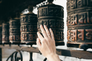 female hand touches the Buddhist prayer drum, Nepal